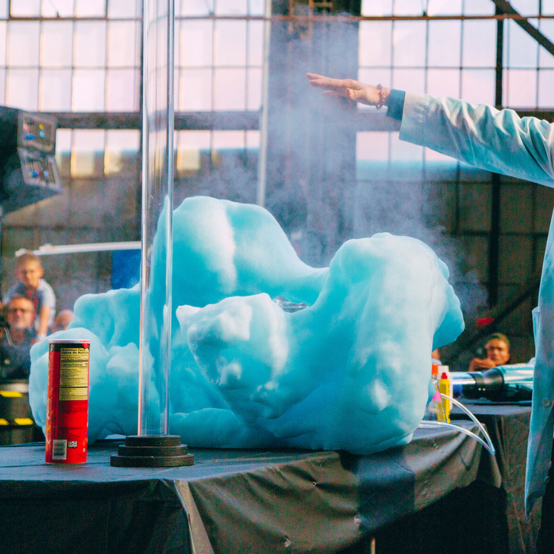 Science & Tech demonstration featuring blue foam eruption and science experiment in a laboratory setting.
