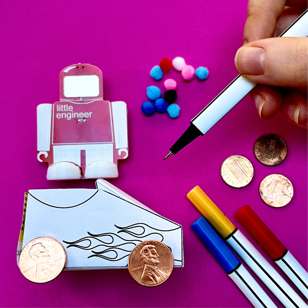 STEM Kits - Pizza Racer project with engineering tools, craft materials, and a cartoon robot on a pink background.