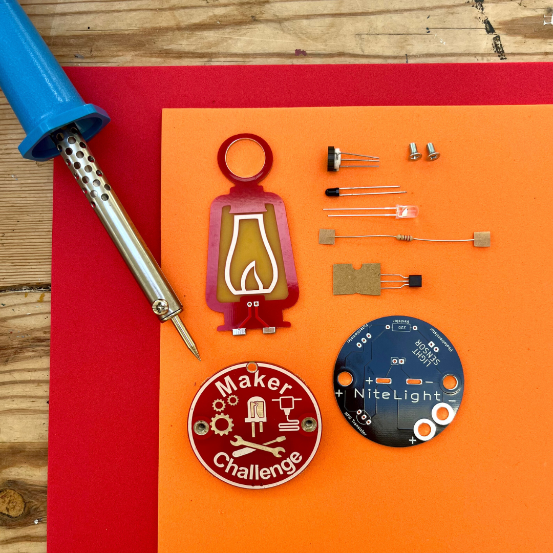 Learn To Solder - NiteLight Lantern components including soldering iron, circuit boards, and electronic parts.