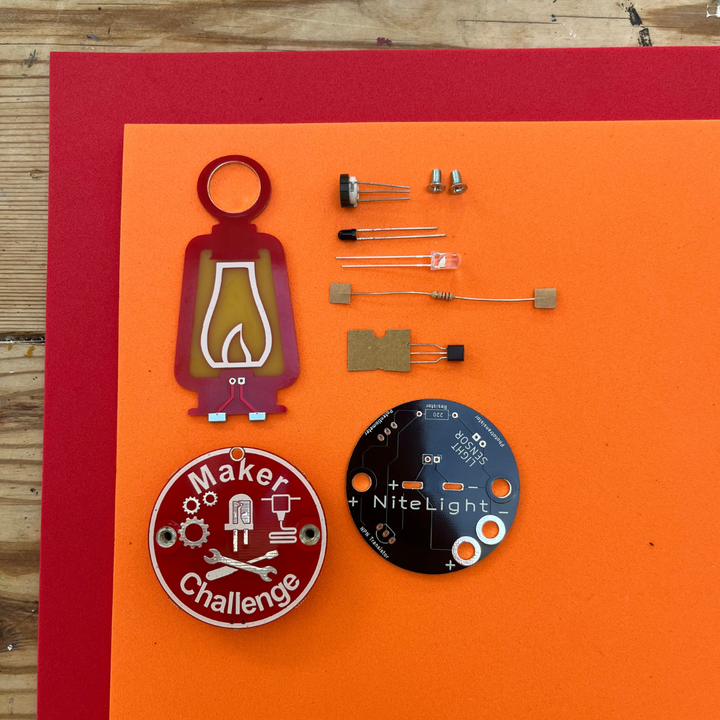 Learn To Solder - NiteLight Lantern kit components including LED, transistors, and assembly parts on vibrant background.