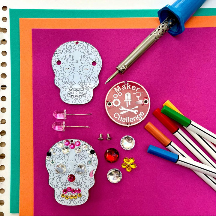 Learn To Solder - Sugar Skull kit components including LEDs, sugar skull circuits, soldering tools, and embellishments.