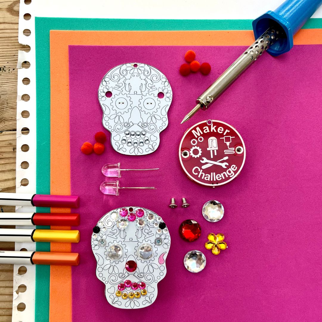 Learn To Solder - Sugar Skull soldering kit components including skulls, LEDs, and decorative elements.