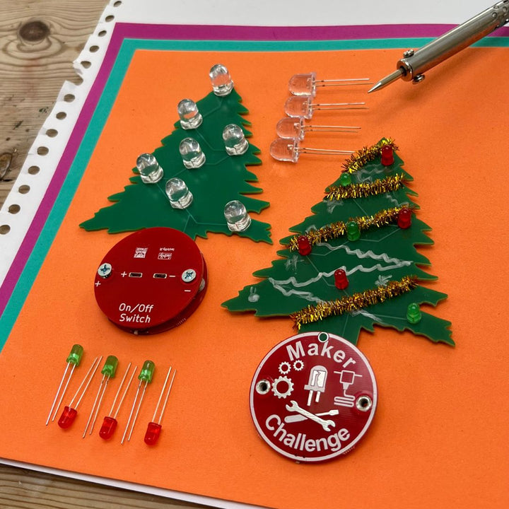 Learn To Solder - Holiday Tree kit components including trees, LEDs, and on/off switch for creative crafting.