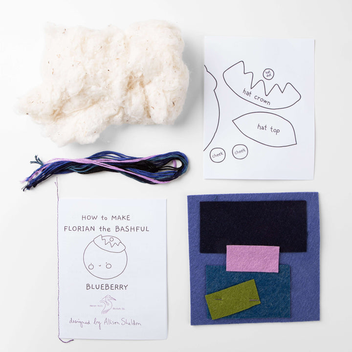 Florian the Bashful Blueberry Felt Stitching Kit components including felt, thread, and instructions to create a plush toy.