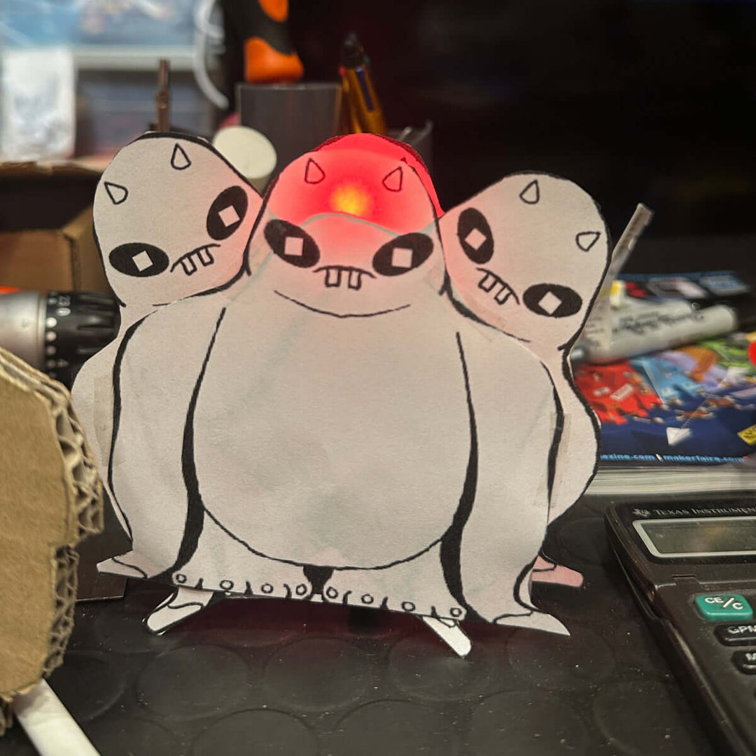 Make A Monster Craft Kit featuring a colorful design of three playful monsters with glowing eyes.
