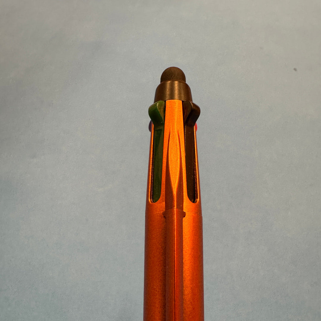 Close-up of an orange pen on a gray background
