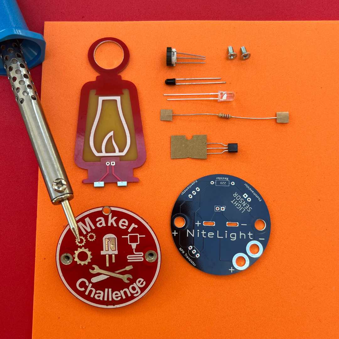 Learn To Solder - NiteLight Lantern components including a soldering iron, circuit boards, and electronic parts.