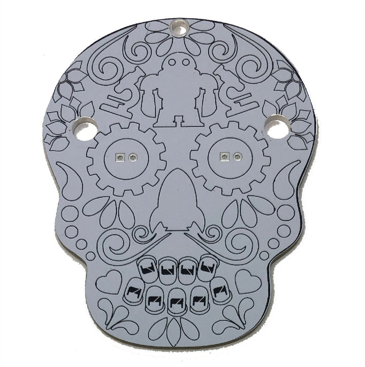 Learn To Solder - Sugar Skull circuit board for a DIY electronics project with unique skull design.