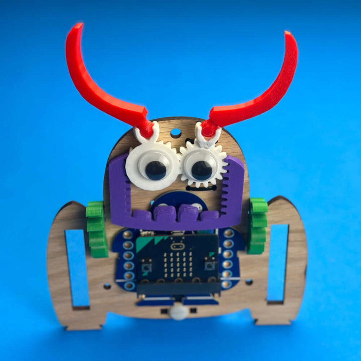 Very Useful Monsters Robotic Workshop Kit featuring the GabbE robot model with googly eyes on a blue background.