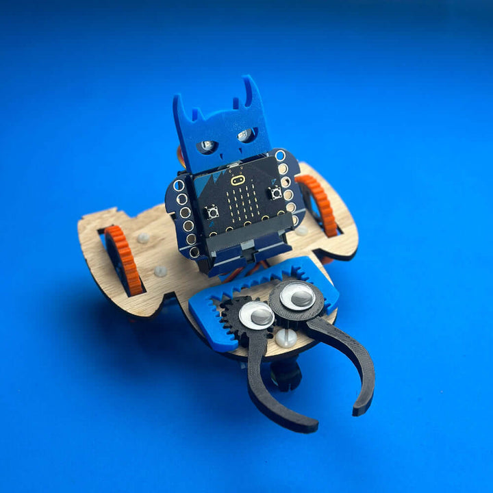 Very Useful Monsters Robotic Workshop Kit featuring the GrabbE robot model with wheels and grabbing pinchers.