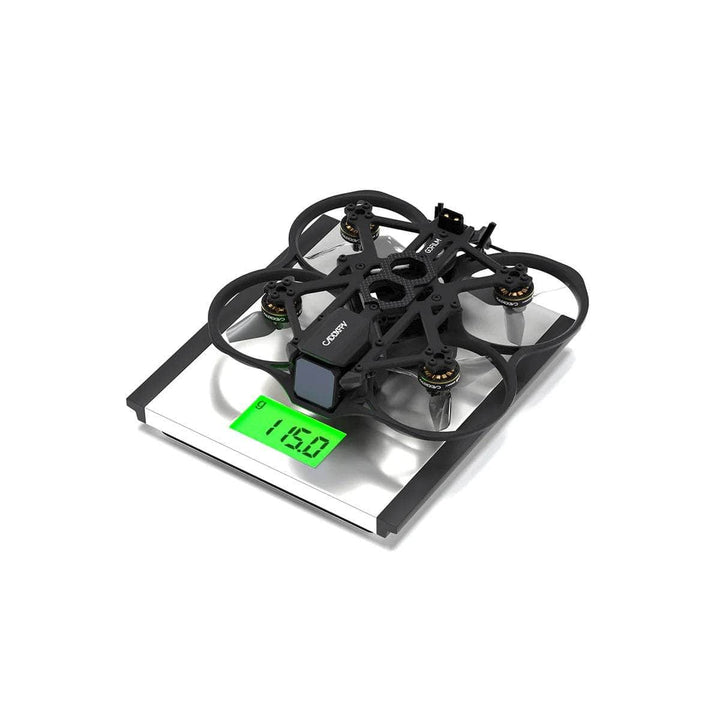 Caddx BNF Gofilm 20 FPV drone on a scale showing 115.0 grams weight.